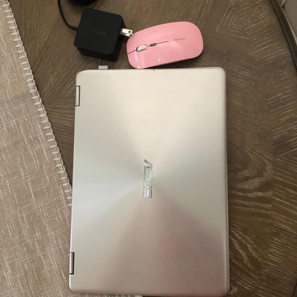 ASUS Metallic Silver Convertible Laptop with a wireless mouse and a charger.
